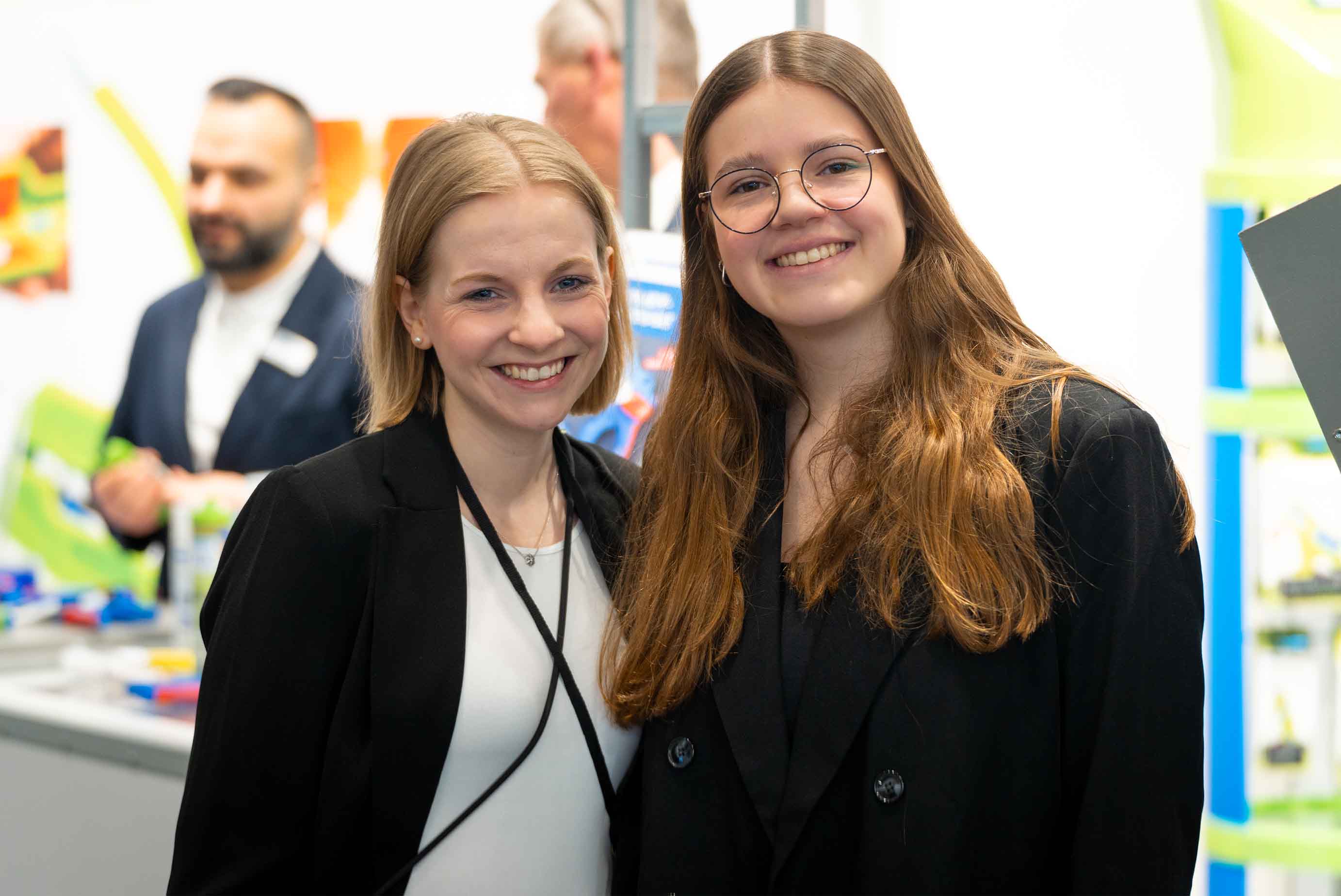 people, women, blazer, glasses, name tag