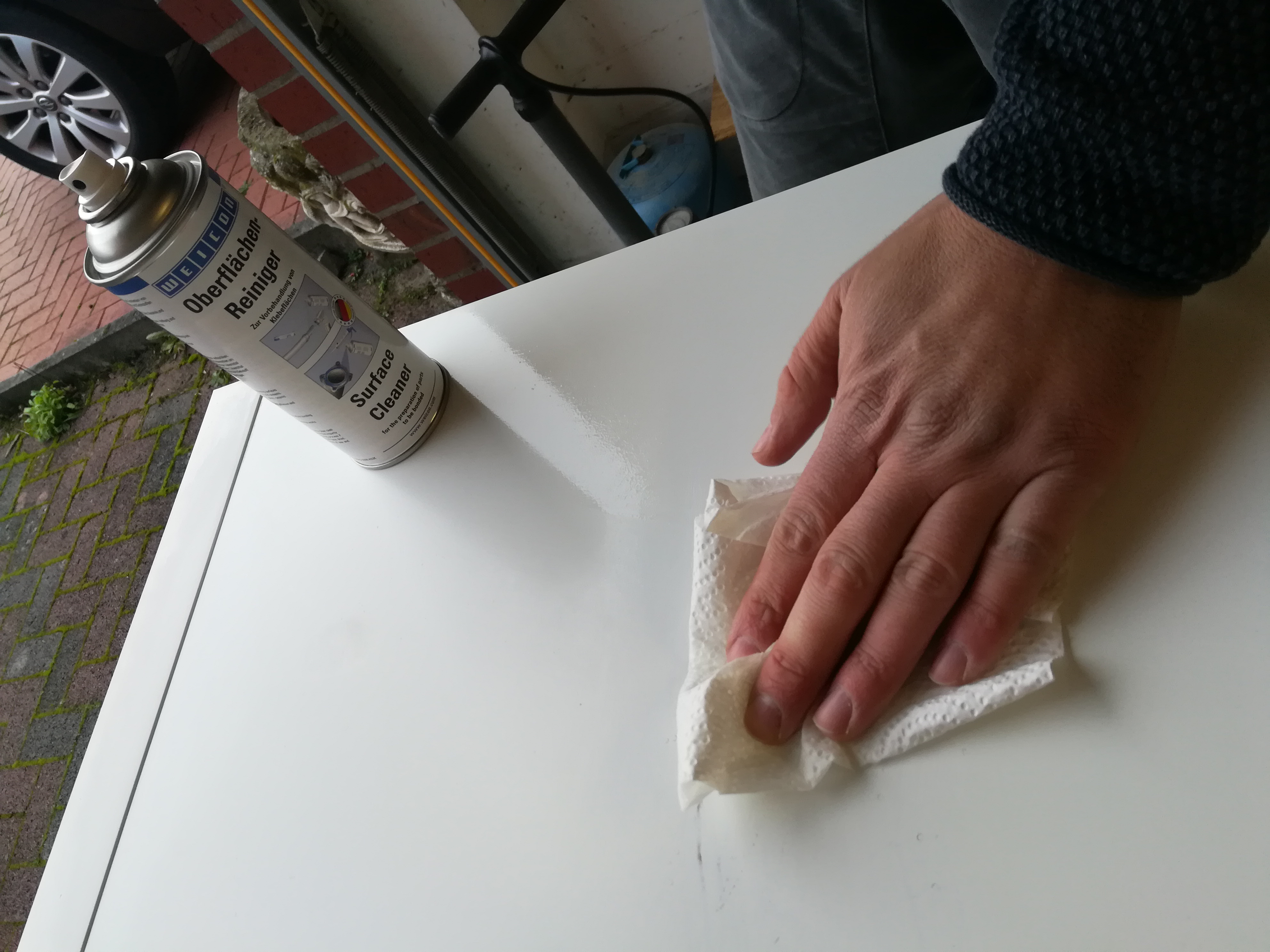 surface cleaner, spray can, cleaning, white tabletop, hand wiping surface